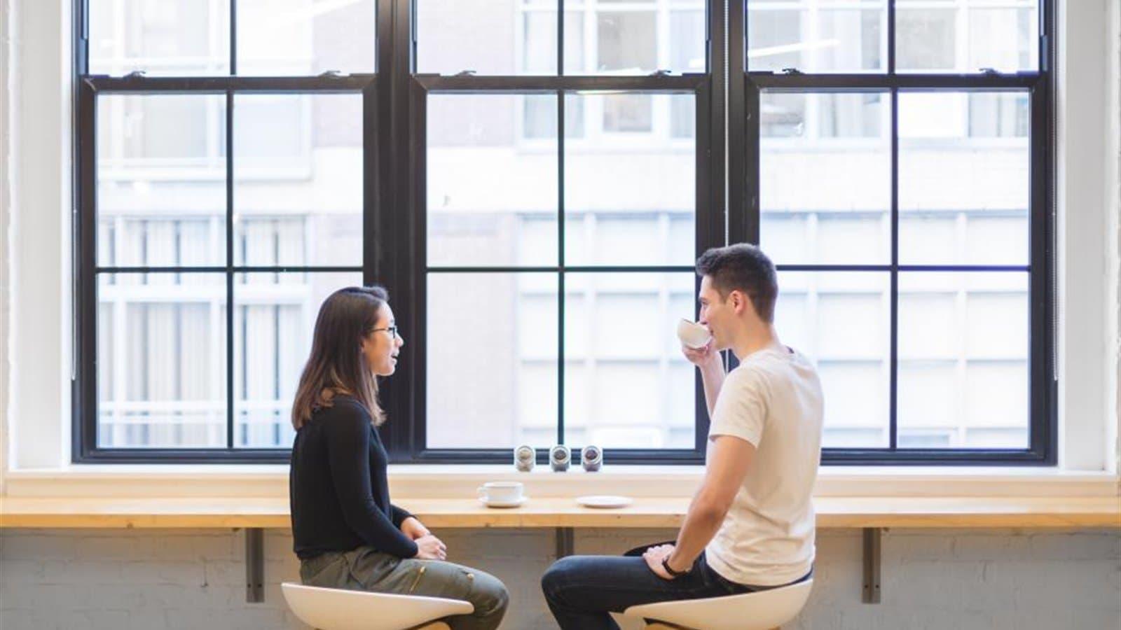 カフェのような場所で向き合って話す男女